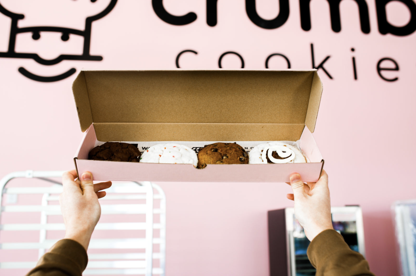Crumbl Cookies (pink background, box of cookies)